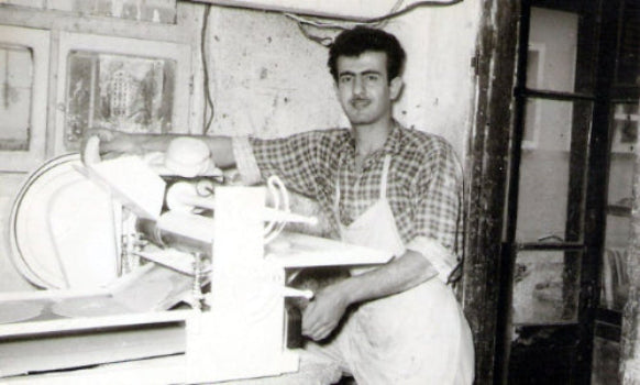 Man baking cookies, cakes, and muffins with a machine in Kermanig bakery